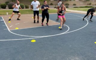 A group of people playing frisbee golf on the court