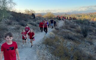 A group of people walking up a hill