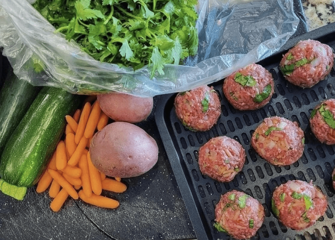 A grill with meat and vegetables on it