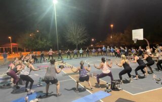 A group of people doing different exercises on the ground.