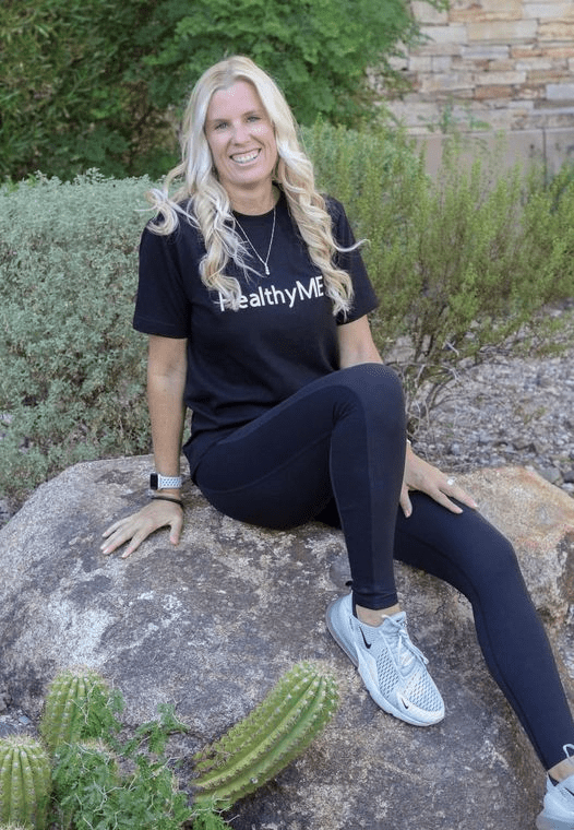 A woman sitting on top of a rock.