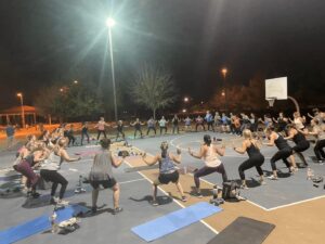 A group of people doing different exercises on the ground.