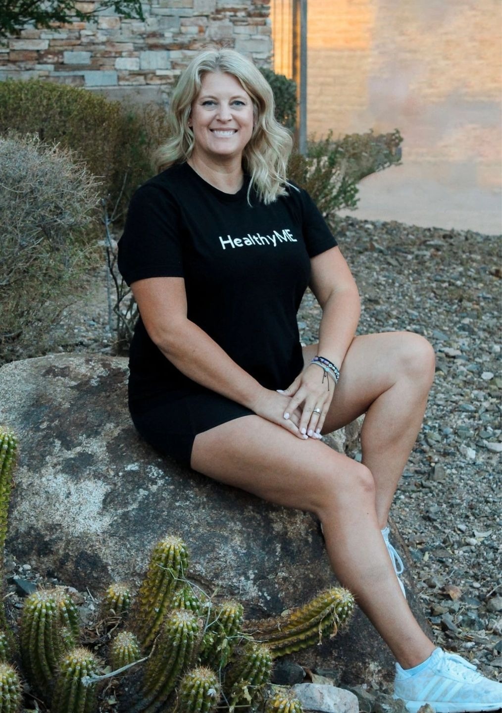 Woman in black shirt with "Healthy Me" text.