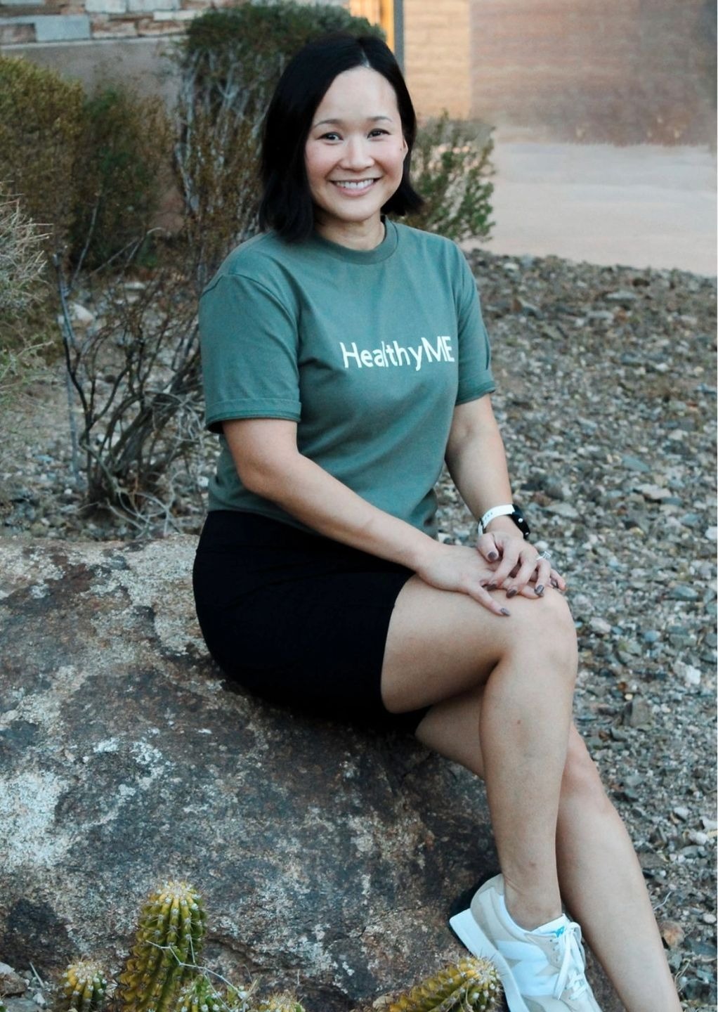 Woman in green shirt with "Healthy ME" logo.