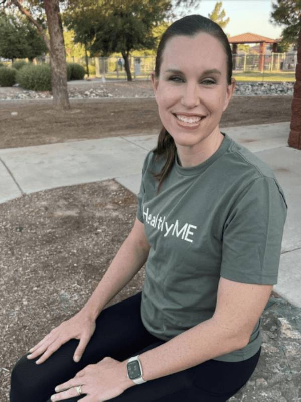 Woman smiling in a "Healthy Me" shirt.